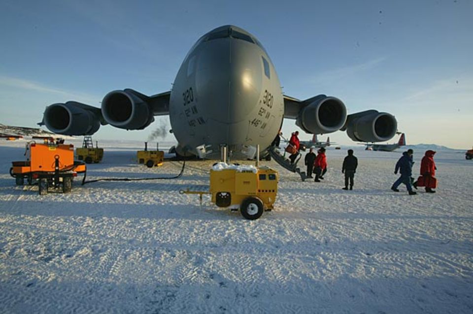 Nicht etwa eine Cessna, sondern ein Militärflugzeug, das das Gewicht von 20 LKWs tragen könnte, fliegt die Expeditionsteilnehmer in die Antarktis Nicht etwa eine Cessna, sondern ein Militärflugzeug, das das Gewicht von 20 LKWs tragen könnte, fliegt die Expeditionsteilnehmer in die Antarktis