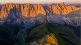 Die Szenerie erinnert an Patagonien. Markante Felsklippen strahlen golden im Abendlicht, tief unten liegen die eingeschnittenen Täler bereits im Dunkeln