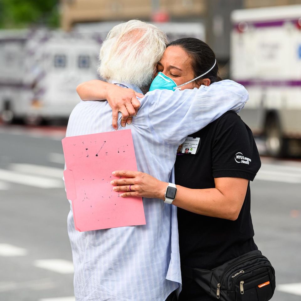 NEW YORK, NEW YORK - MAY 29: A medical worker hugs a COVID-19 survivor outside NYU Langone Health hospital during the coronavirus pandemic on May 29, 2020 in New York City. Government guidelines encourage wearing a mask in public with strong social dist...