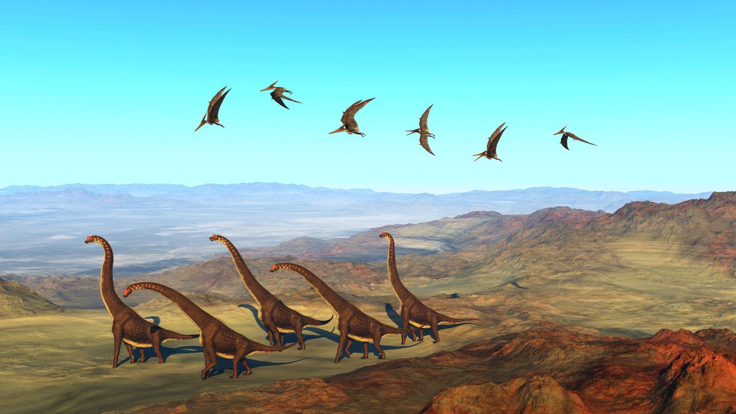 Dinosaurier wandern über einen erloschenen Vulkan in Afrika