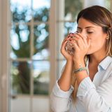 Frau trinkt eilig ein Glas Wasser, weil sie Durst hat
