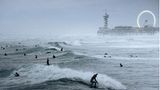 Image Name: Surfing Festival  Photographer Name: Raido Nurk  Year: 2022  Image Description: <p>The waves were the biggest I’ve ever seen in the evening when I took this photo in The Hague, Netherlands. The waves and the pouring rain created quite a unique atmosphere.</p>  Copyright: © Raido Nurk, Estonia, Winner, National Awards, Motion, 2022 Sony World Photography Awards
