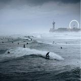 Image Name: Surfing Festival  Photographer Name: Raido Nurk  Year: 2022  Image Description: <p>The waves were the biggest I’ve ever seen in the evening when I took this photo in The Hague, Netherlands. The waves and the pouring rain created quite a unique atmosphere.</p>  Copyright: © Raido Nurk, Estonia, Winner, National Awards, Motion, 2022 Sony World Photography Awards