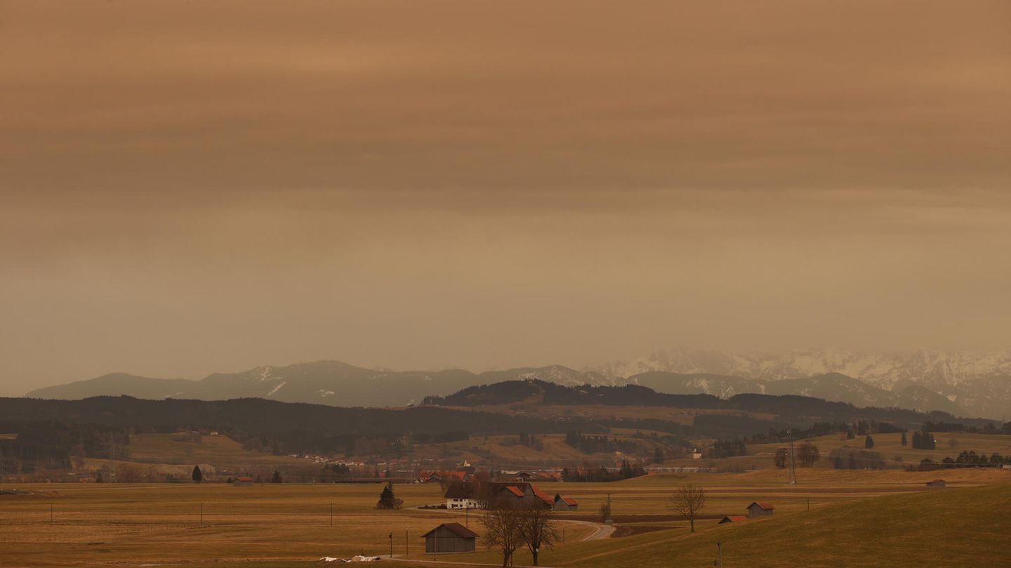 Bayern, Ruderatshofen: Saharastaub färbt den Himmel in rötliche Farbtöne