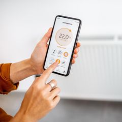 Frau steuern Heizung per App
