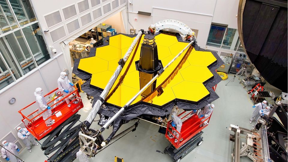 Wissenschaftlerinnen und Wissenschaftler der NASA, der US-amerikanischen Bundesbehörde für Raumfahrt und Flugwissenschaft, tüfteln am James Webb Teleskop. 