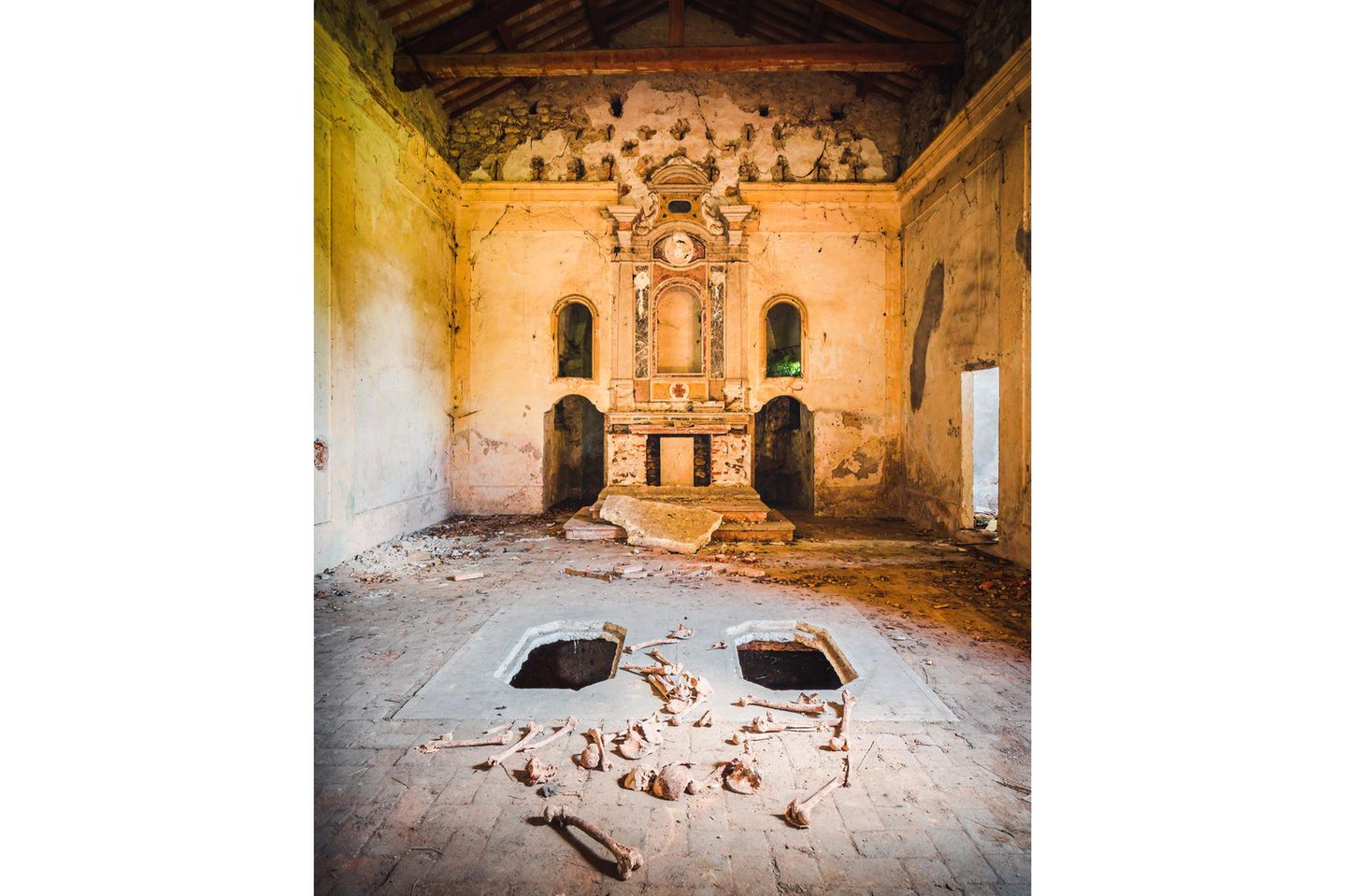 Photo 8: This church is part of an abandoned monastery with a very long history, located in Northern Italy. Founded in the Middle Ages, near the end of the 12th century, and occupied for about 600 years. Near the end of the 18th century it got closed due to constant complaints of the critical condition of the building. Striking for the current state of the complex is the huge amount of vandalism, and in particular this church which is only a small part of the complex. The archeologic value is quite high. Historic pottery, wooden coffins and nails got destroyed and people have even tried to steal the big marmer Roman column in the altar you see on the picture. The heavy weight of the column probably prohibited the thieves to take it.