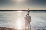 Couple standing at Lake Cospuden in the evening, Sachsen