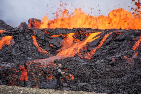 Zwei Menschen beobachten den Vulkanausbruch auf Island