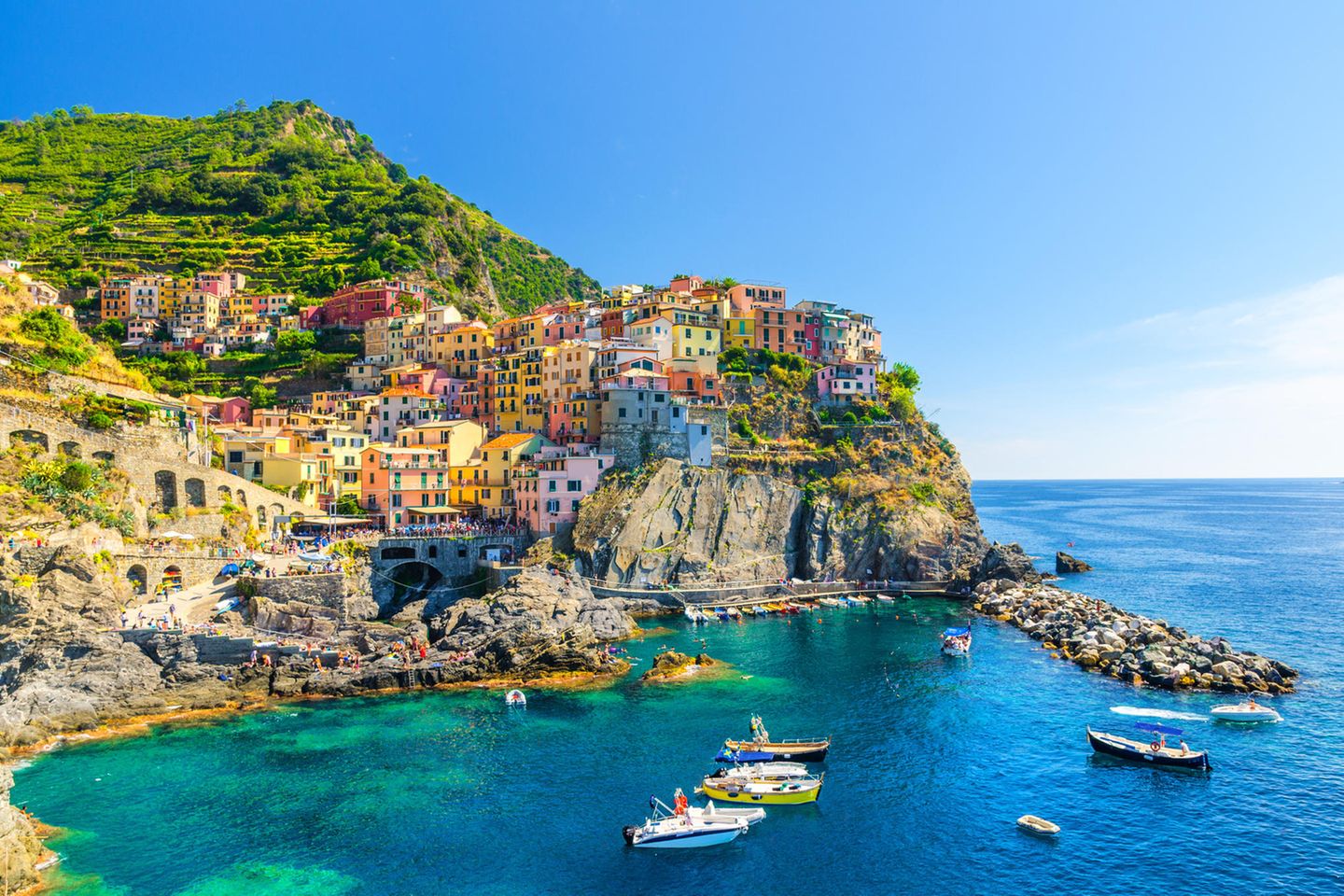 Manarola: Bilderbuchdorf mit Fischerhafen Boote dümpeln im Wasser vor Manarola, Cinque Terre