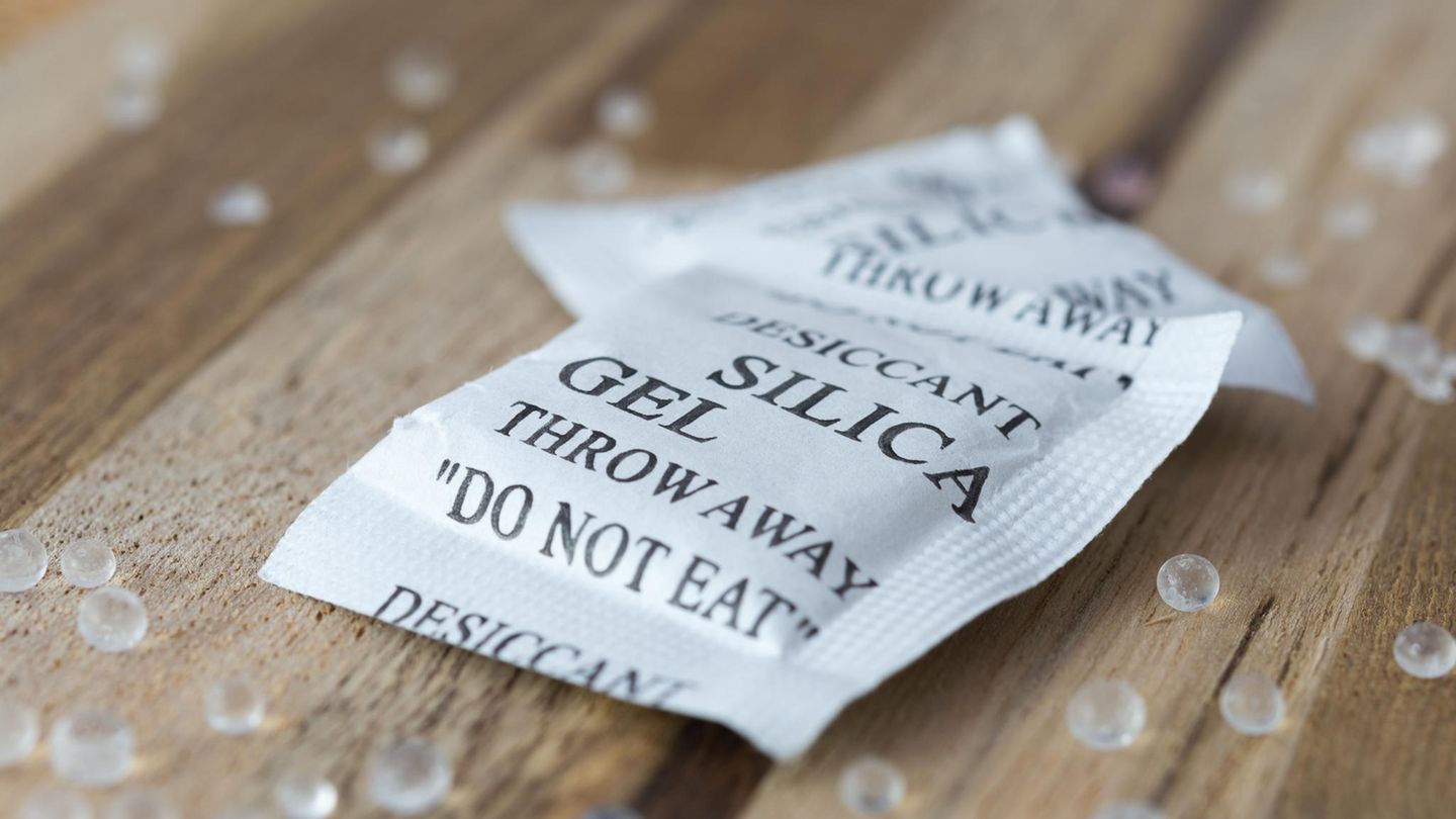Silica-Gel-Tütchen liegt auf einem Holztisch