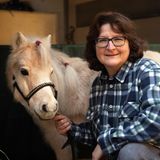 Auf der linken Seite ist ein helles Pony, auf der rechten Seite eine Frau