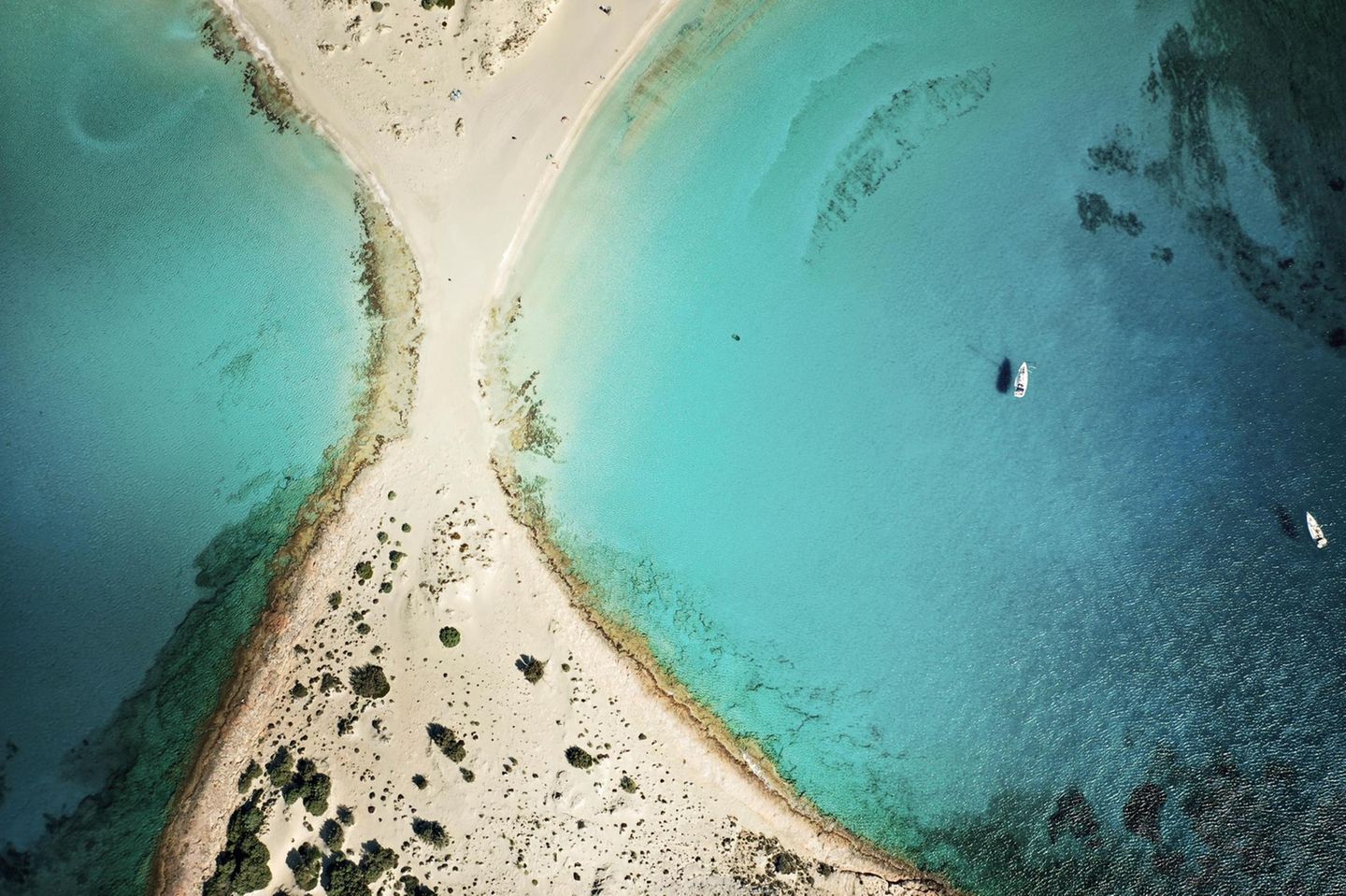 Vor der Insel Elafonisos ragt der Strand in Form einer Eieruhr ins Meer und teilt es in zwei Buchten. Die Insel liegt südlich des Peloponnes. Und wie in einer Eieruhr ist der Sand feinkörnig und beinah weiß