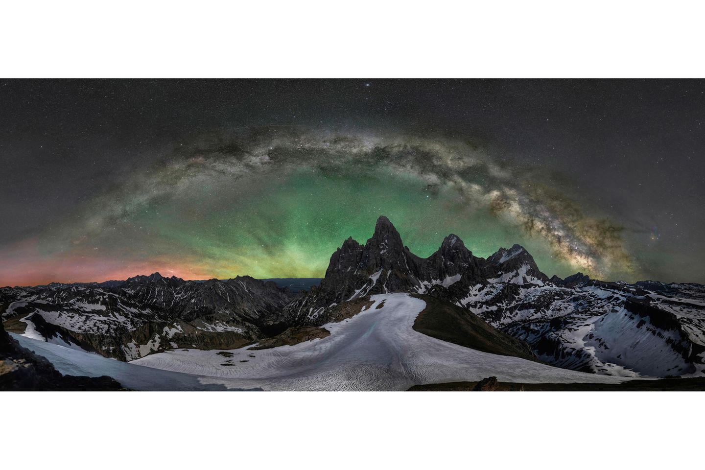 GOLD: JAKE MOSHER, USA  On June 17th, 2021, I hiked, snowshoed, and climbed to the 11,000-foot summit of Wyoming's Table Mountain to photograph the Milky Way over Grand Teton Peak. While these iconic mountains have been photographed tens of thousands of times, I wanted to show an entirely unique view of them. I was treated to one of the most spectacular displays of airglow that I've ever seen - similar to the aurora and created by photo-charged particles, but spanning much of the horizon.