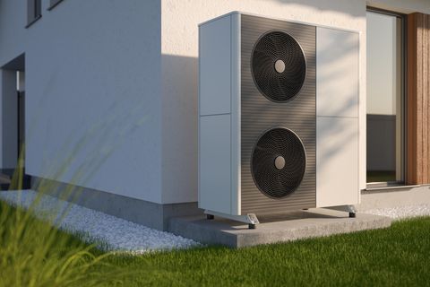 Modell einer Wärmepumpe vor einem Haus