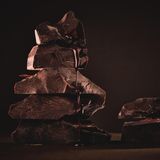 Ein Stapel aus Schokoladenstücken vor braunem Hintergrund