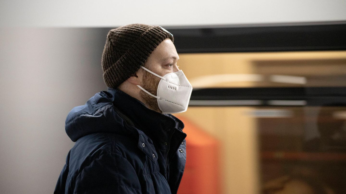 Mann mit Corona-Maske fährt U Bahn