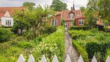 Denmark, Region of Southern Denmark, Aeroskobing, Flowers blooming in front yard of traditional Danish house