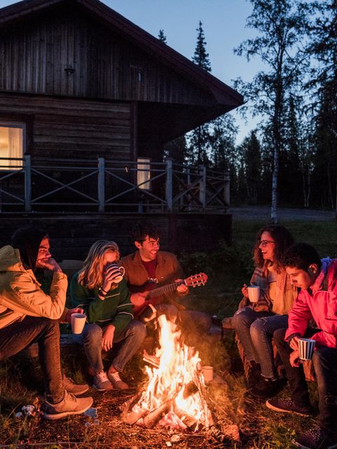 Gruppe von Personen sitzt an einem Lagerfeuer