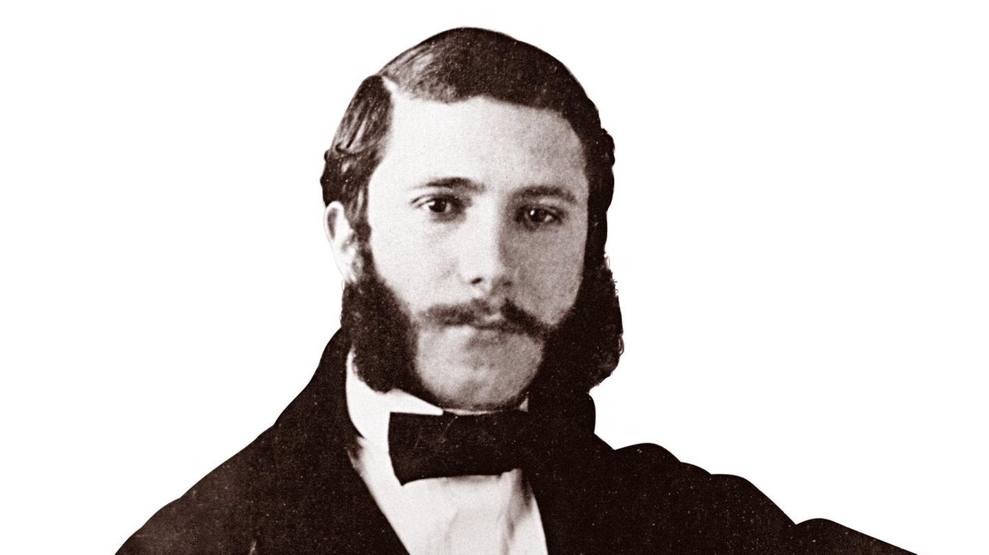 Foto des jungen Henry Dunant mit Backenbart und Anzug Foto des jungen Henry Dunant mit Backenbart und Anzug