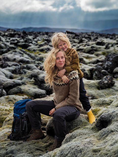 Mutter mit Kind vor einem felsigen Hintergrund