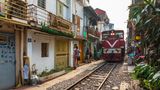 View of Hanoi train street between Le Duan and Kham Thin Street in Hanoi old quarter, Hanoi, Vietnam, Asia with a train travelling from Hanoi station