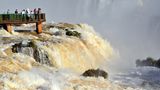 Brazil, Iguassu National Park: Tourists appreciating Iguassu Falls with record water levels from a panorama platform