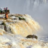 Brazil, Iguassu National Park: Tourists appreciating Iguassu Falls with record water levels from a panorama platform
