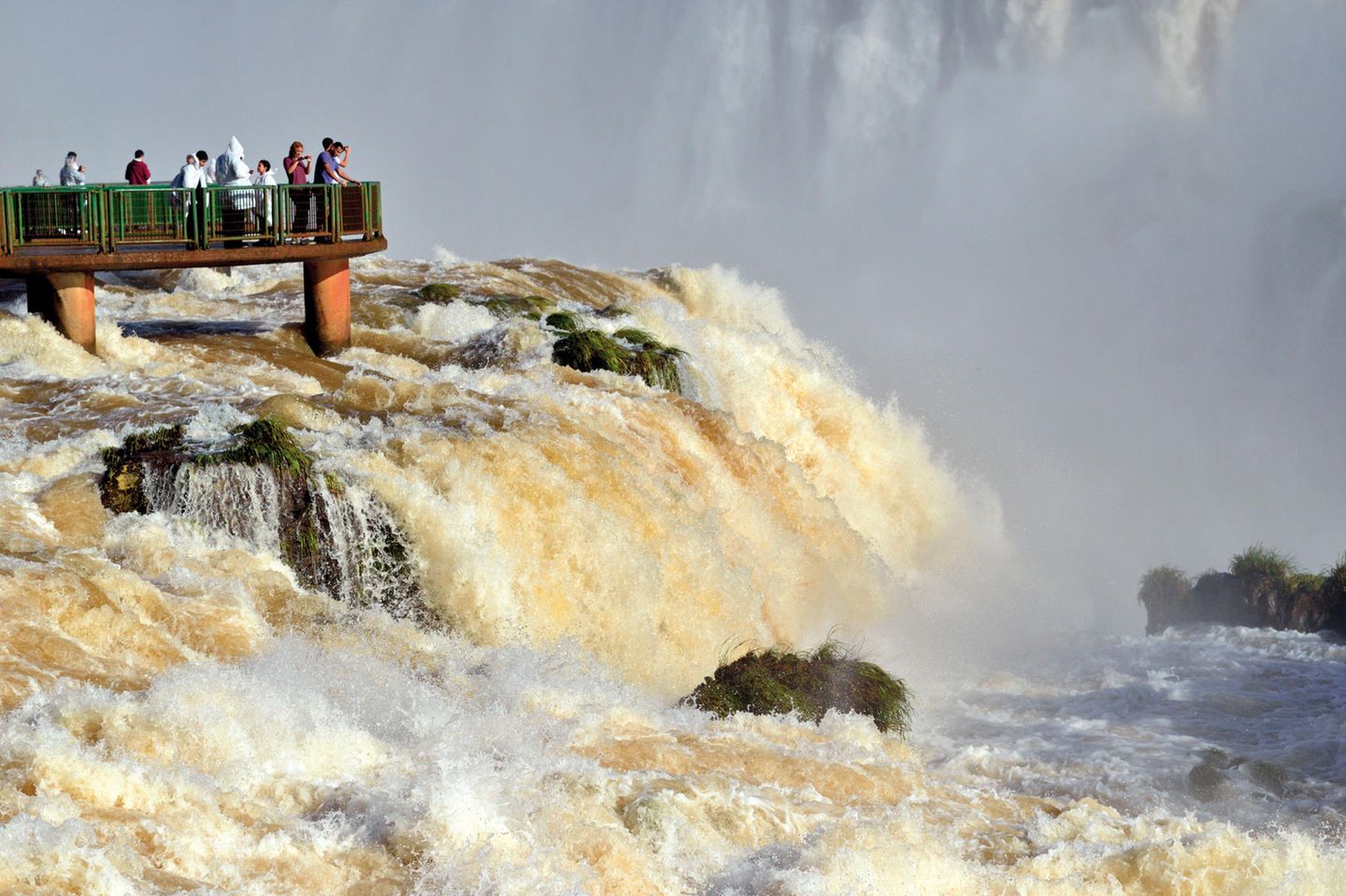 Brazil, Iguassu National Park: Tourists appreciating Iguassu Falls with record water levels from a panorama platform