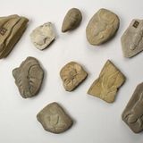 Steine mit simplen Reliefs verschiedener fantastischer Wesen, z.B. Fröschen und Insekten