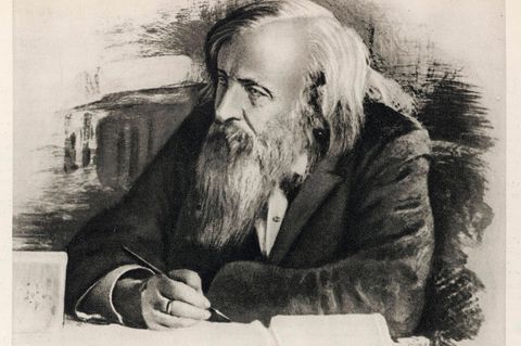 Dmitri Iwanowitsch Mendelejew am Tisch sitzend und schreibend mit Feder in der Hand