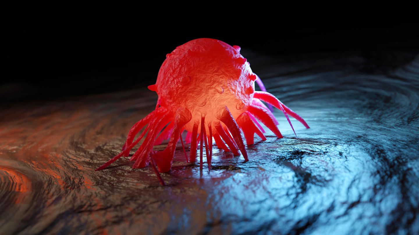 Ein rot leuchtende Krebszelle hält sich mit Tentakeln an Gewebe fest
