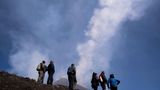 Menschen beobachten Wirbelringe am Himmel über dem Ätna