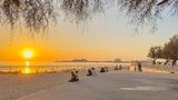 Strand mit Menschen bei Sonnenuntergang