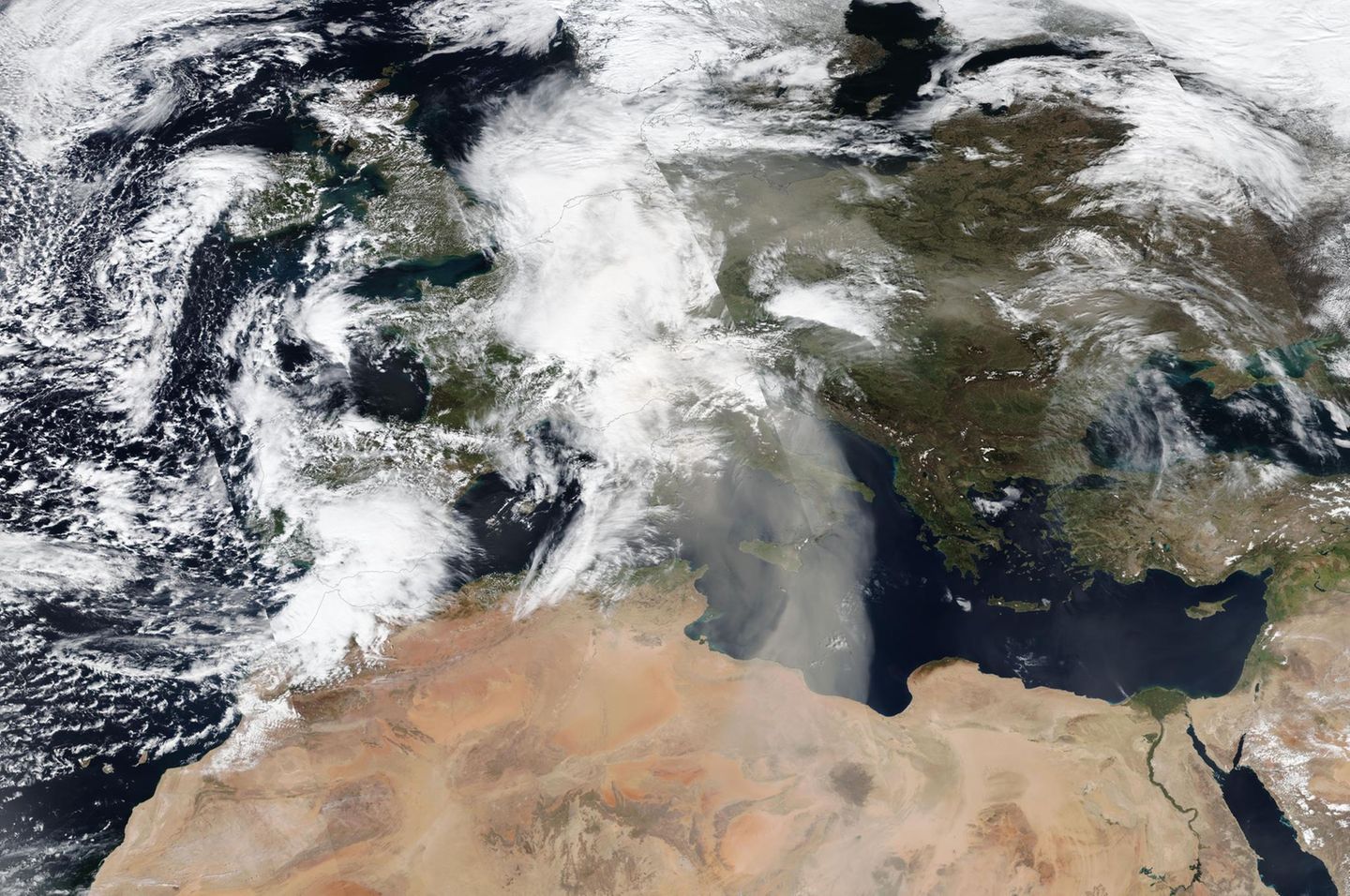 Die Satellitenaufnahme vom 30. März 2024 zeigt dichte Schlieren von Saharastaub über dem Mittelmeer. Mit günstigen Winden schaffen es die winzigen Partikel bis in den Norden Deutschlands