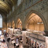 Interior of Dominican church converted into a bookstore with restaurant, customers, cathedral ceilings and pillars of the church in Maastricht, Netherland