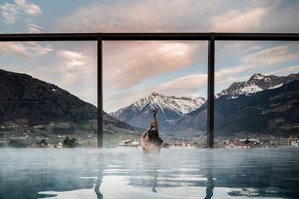 Frau im Wasser vor Bergpanorama