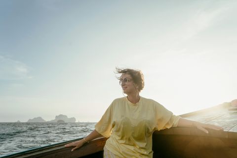 Eine reife Frau sitzt auf dem Boot