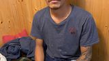 Mann sitzt am Tisch, Tattoos auf dem Arm