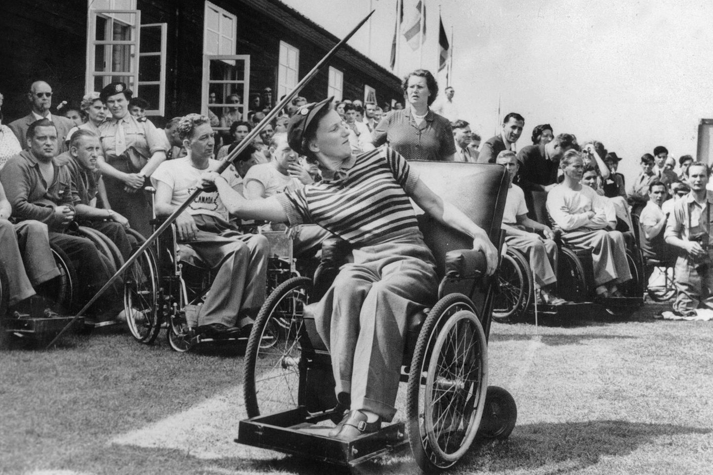 Woman in wheelchair waves spear