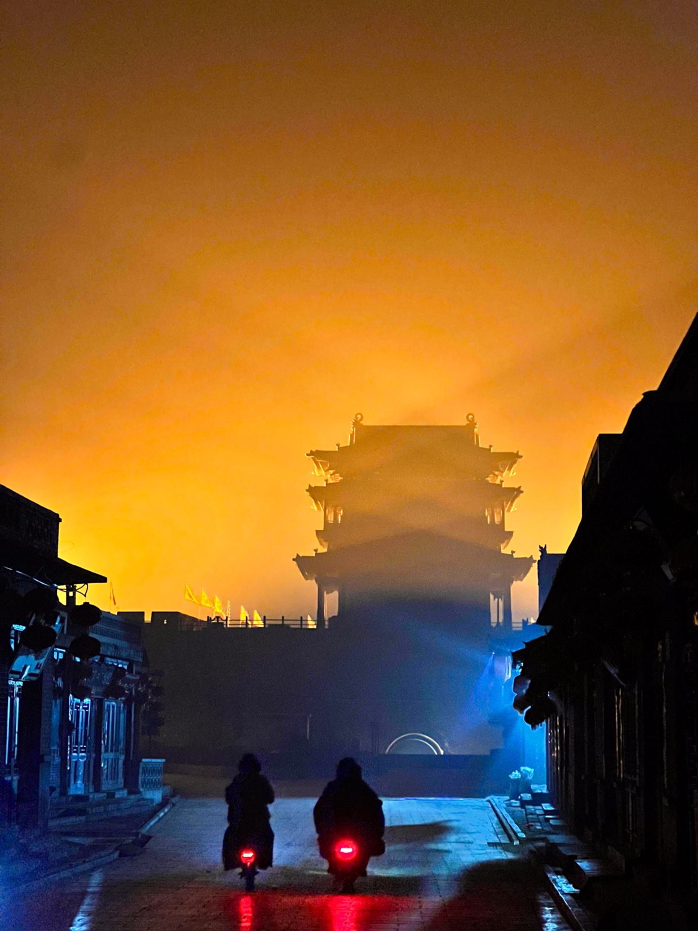 Zwei Mopeds vor einem Tempel in einer nebligen Nacht