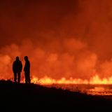 Zwei Menschen bestaunen den Vulkanausbruch auf Island
