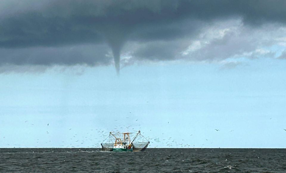 Ein Tornado bildet sich über einem schwimmenden Fischerboot vor der Insel Borkum