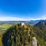 Germany, Bavaria, Pfronten, Aerial view of ruins of Falkenstein Castle standing on top of forested Falkenstein mountain
