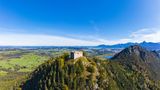 Germany, Bavaria, Pfronten, Aerial view of ruins of Falkenstein Castle standing on top of forested Falkenstein mountain