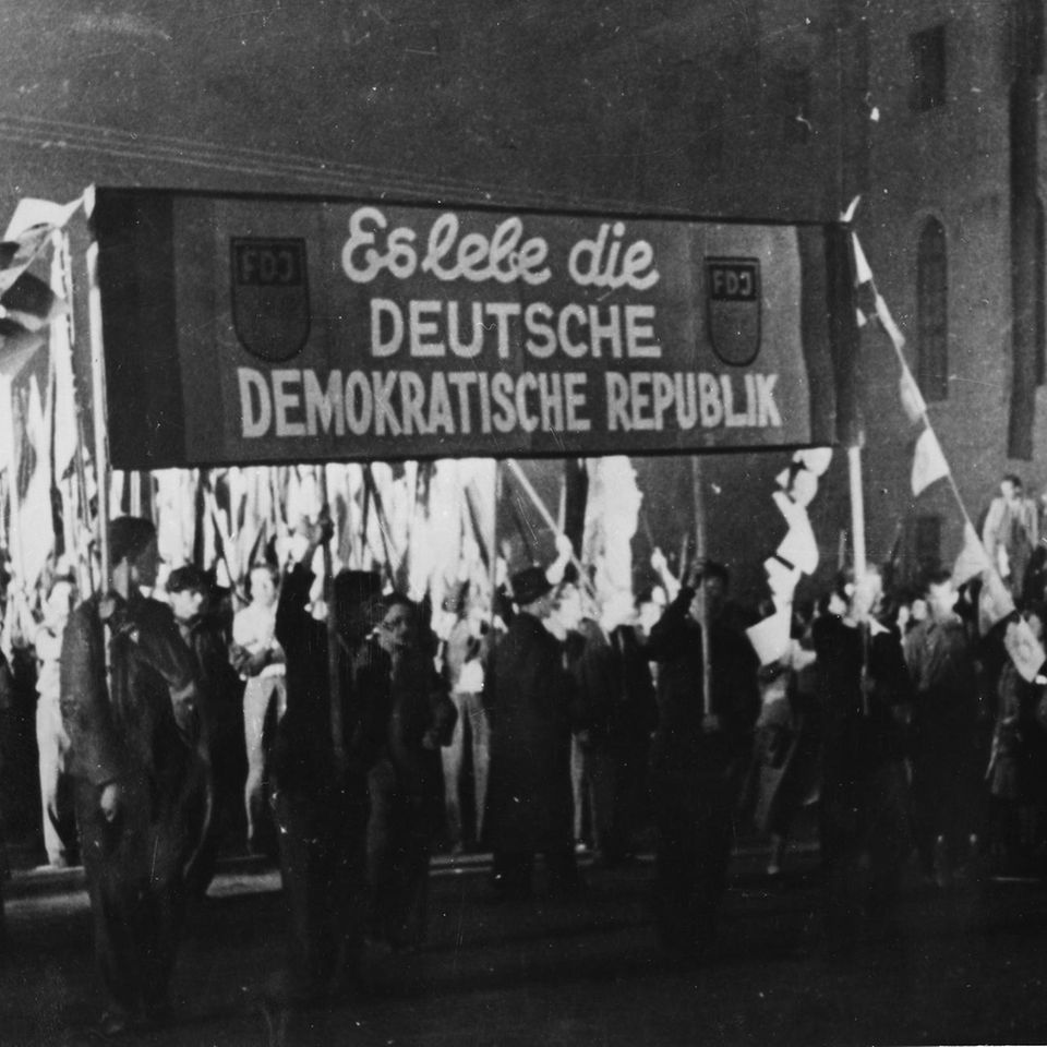 Menschen tragen Banner "Es lebe die Deutsche Demokratische Republik"