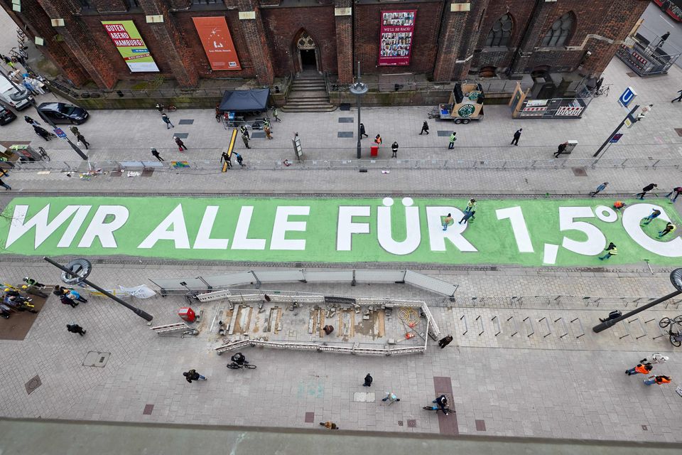 Zum siebten globalen Klimastreik im März 2021 malten Aktivistinnen und Aktivisten der Gruppe Fridays for Future einen Appell für die Einhaltung des 1,5-Grad-Ziels auf eine Straße in der Hamburger Innenstadt 1.5215