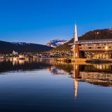 die sich im Wasser spiegelnde Stadt, eingehüllt im warmen Licht der Mitternachtssonne