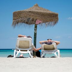Zwei Menschen liegen am Strand