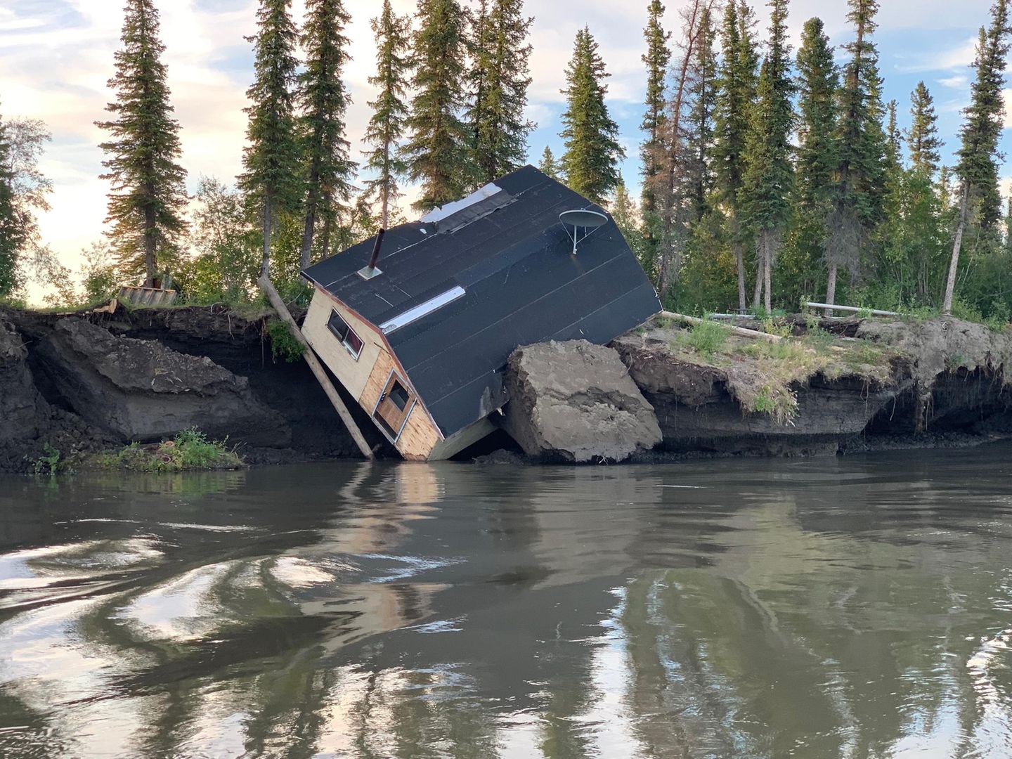 Eine umgekippte Hütte, die im Zuge von Permafrost-Tau und Erosion am kanadischen Mackenzie-Flussdelta zerstört wurde